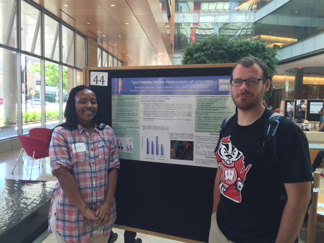 two students presenting posters